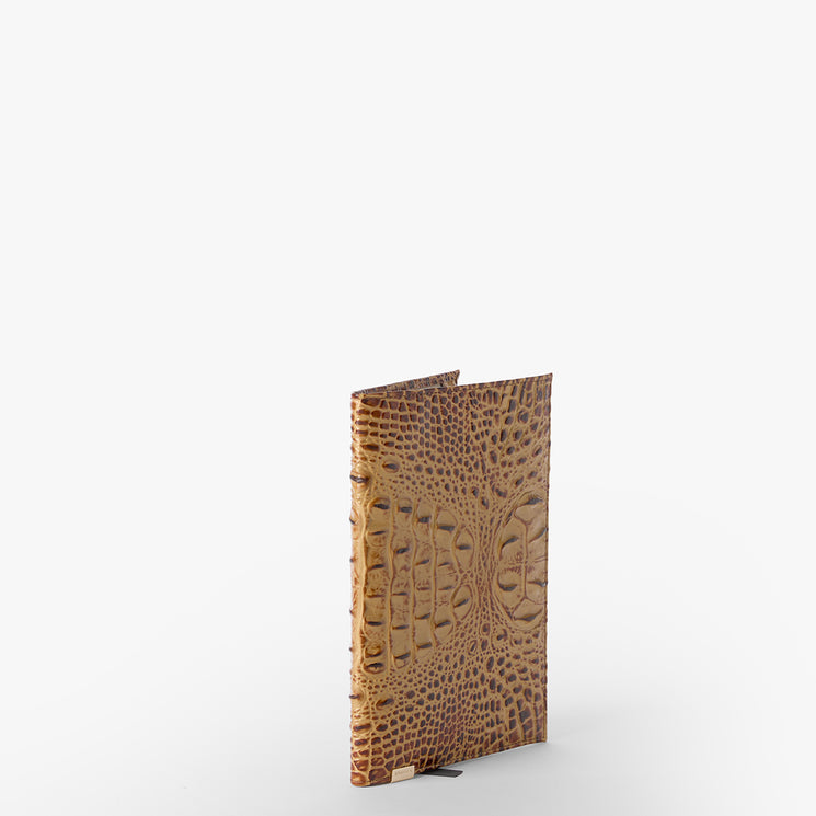 Brahmin brown textured journal with embossed crocodile-inspired pattern, shown upright on a white surface with plain white background; features structured silhouette and refined detailing.