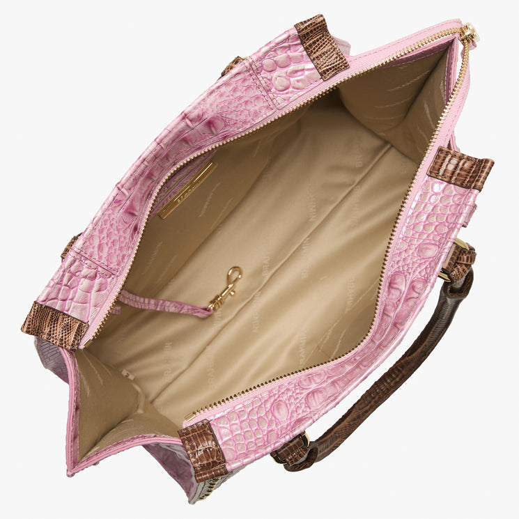 Brahmin pink embossed handbag with brown top handles, beige interior, zippered pocket, slip pocket, and gold-tone key leash visible. Bag shown open to display interior details and textured pattern.