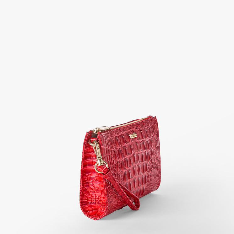 Brahmin red wristlet bag with embossed textured pattern, gold-tone hardware, and wrist strap. Compact rectangular silhouette shown on white background. Brahmin logo plaque visible near the top.