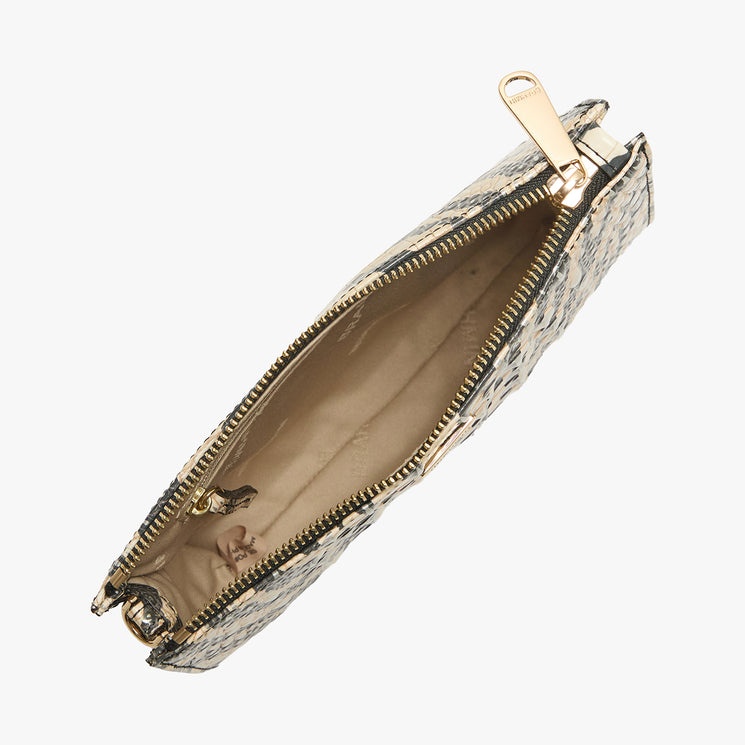Top view of an open Brahmin clutch with gold zipper, beige interior, and small inner pocket. The exterior features a textured, patterned design. The bag’s silhouette and structured shape are clearly visible.