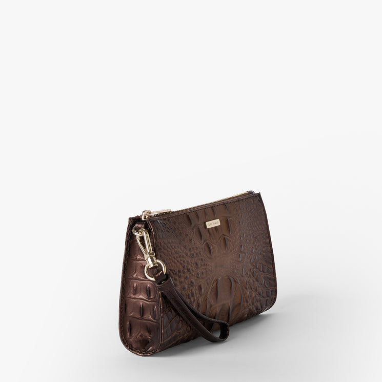 Brahmin brown wristlet clutch featuring an embossed textured pattern, gold-tone zipper closure, and detachable wrist strap. The sleek rectangular silhouette is shown on a white background.