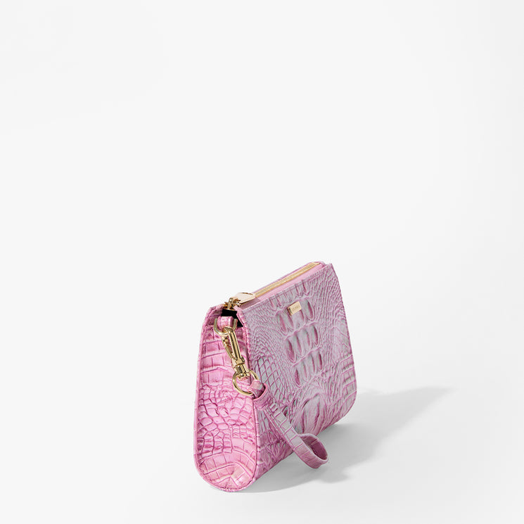 Brahmin clutch bag in light pink with embossed texture, gold-tone zipper and clasp hardware, structured silhouette, shown upright on a plain white background. No strap or interior is visible in the image.