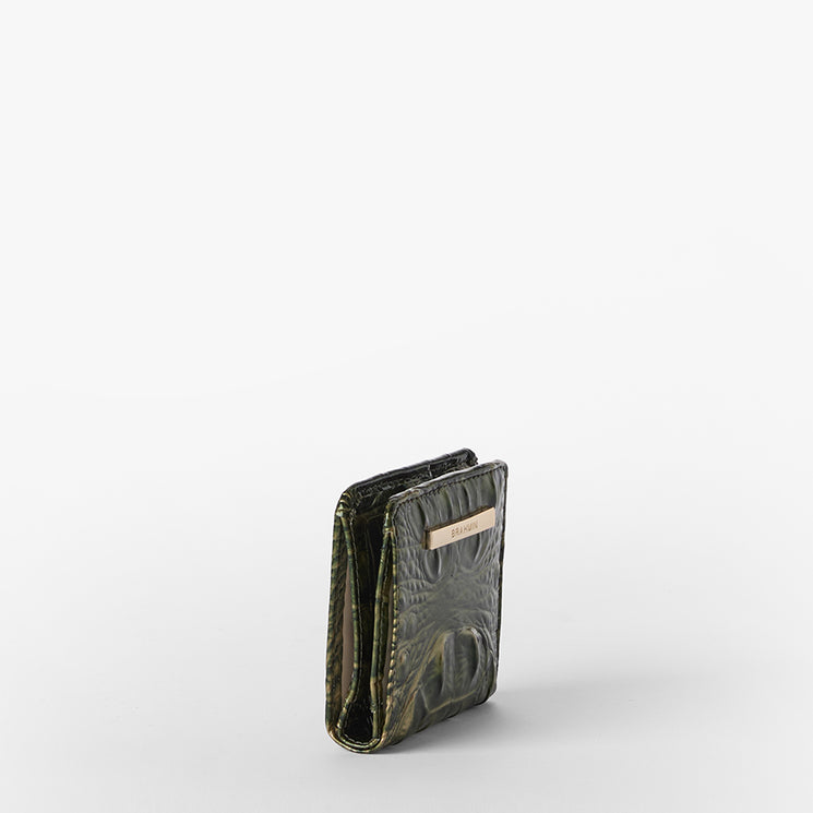 A dark olive green textured wallet with a small beige leather brand tab on the front, standing upright on a light gray background.