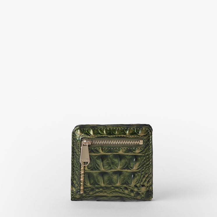 A small green crocodile-embossed leather zip-around wallet with a gold-tone zipper pull, photographed against a clean white background.