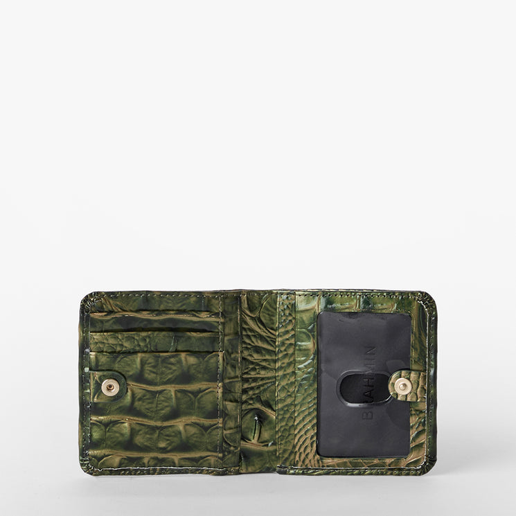 An open green crocodile-embossed wallet with multiple card slots, a black card holder, and gold-tone snap buttons, shown against a plain white background.