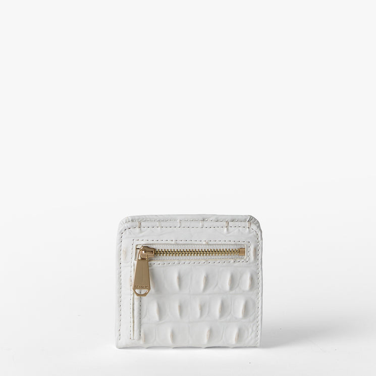 Brahmin small white textured wallet featuring a gold-tone front zipper pocket, rectangular silhouette, and subtle embossed pattern, displayed on a plain white background. No strap or interior is visible.