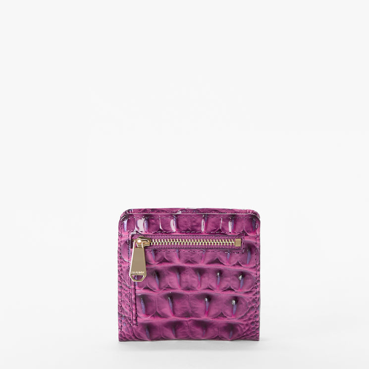 Brahmin square purple wallet with embossed texture, gold-tone zipper pocket on the front, compact silhouette. Displayed against a plain white background. No visible strap or interior details shown.