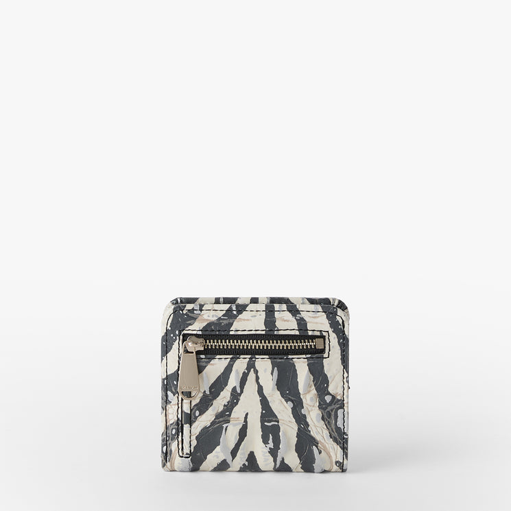 Brahmin square wallet in black and white zebra-inspired pattern, front zippered pocket with metallic hardware, compact silhouette, set on a plain white background.