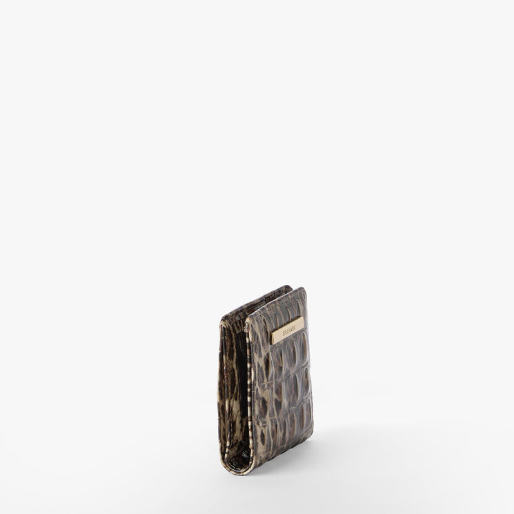 Leopard print wallet with gold accents on a white background. Jane side view.