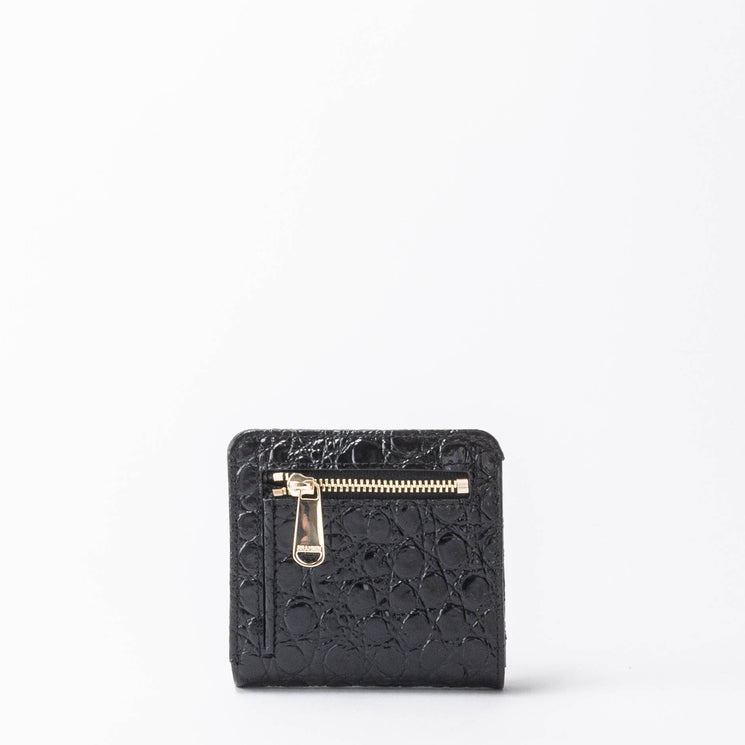 BRAHMIN Jane mini wallet in black textured leather with a gold zipper and pull tab on the front, compact silhouette displayed against a plain white background.