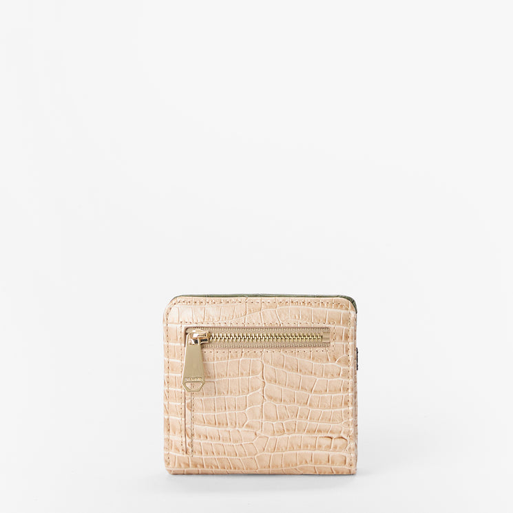 A small beige crocodile-embossed wallet with a gold-tone zipper, shown against a plain white background.