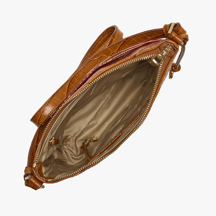 A brown crocodile-embossed leather crossbody bag shown open from a top-down angle, revealing a beige interior lining and gold-tone zipper hardware, set against a plain white background.