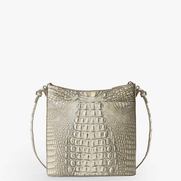 Brahmin square beige shoulder bag with embossed texture, gold-tone hardware, adjustable strap for shoulder wear, displayed upright on white. Bag features structured silhouette and subtle shine.