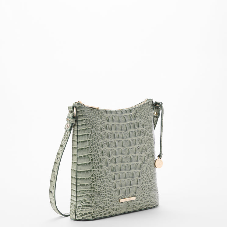 A sage green crocodile-embossed shoulder bag with a matching strap and small gold-tone hardware, photographed on a clean white background.