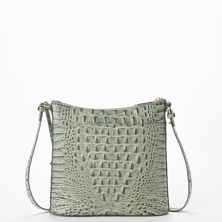 A sage green crocodile-embossed leather crossbody bag with a matching shoulder strap and gold-tone hardware, shown against a plain white background.