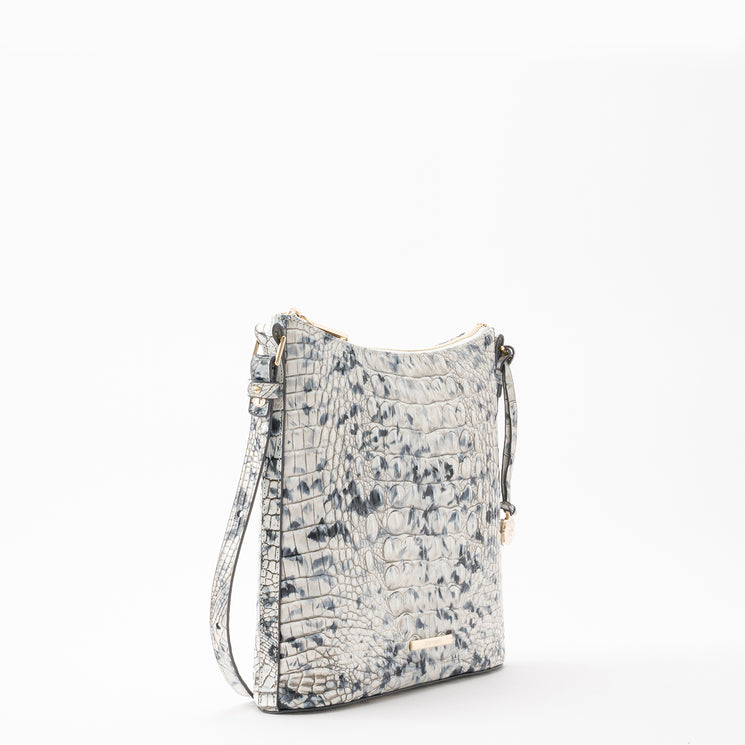 Brahmin Katie crossbody bag in blue and white with an embossed texture, featuring a slim silhouette, gold-tone hardware, zipper closure, and adjustable shoulder strap.