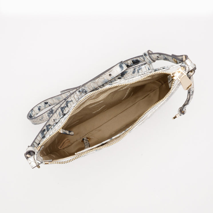 Top-down view of a BRAHMIN Katie Crossbody with a gray and white embossed textured pattern, gold-tone hardware, an adjustable strap, and an open tan interior.