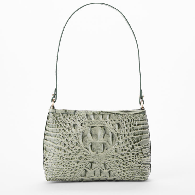A sage green crocodile-embossed shoulder bag with a single top handle and gold-tone hardware, shown against a plain white background.