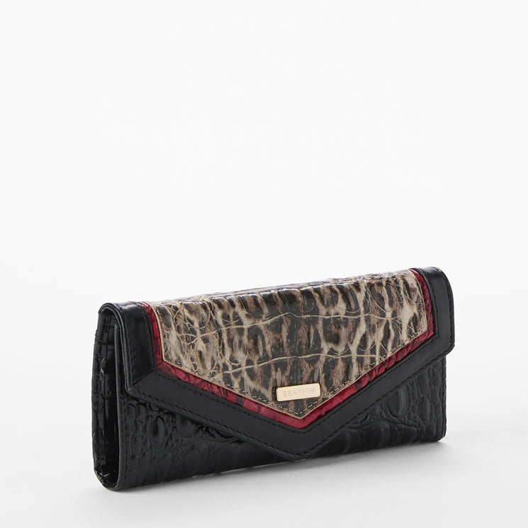 Brahmin wallet with leopard print and black and red leather accents on a white background. Veronica side view.