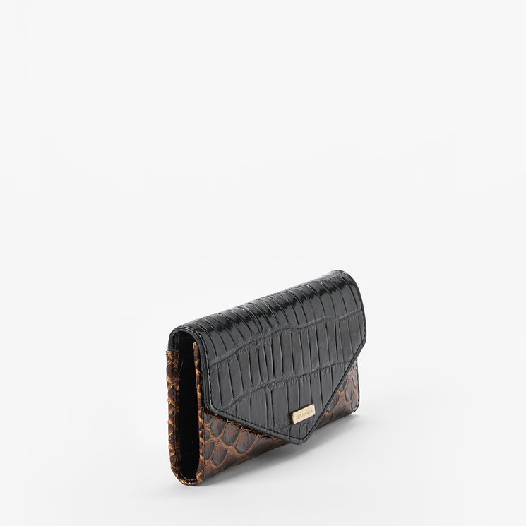 A small black and brown patterned clutch wallet with a crocodile-embossed top flap and a snakeskin-patterned base, featuring a small gold-tone metal plaque on the front, set against a plain white background.