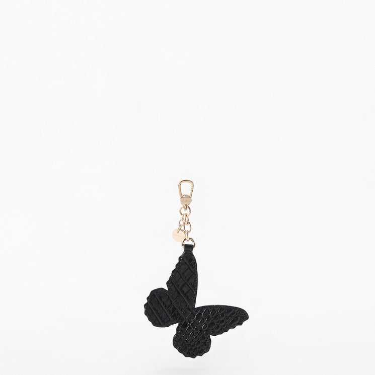 A black textured butterfly-shaped keychain charm with a gold-tone lobster clasp and small heart accent, shown on a plain white background. Back view.