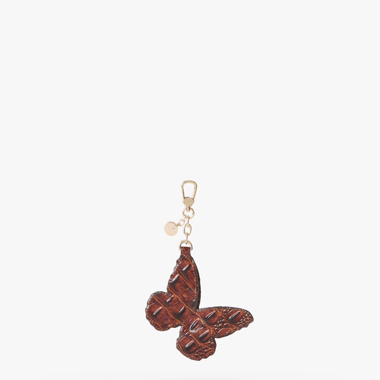 A dark brown textured leather butterfly keychain with a gold-tone lobster clasp and a small round charm, shown against a plain white background. Back view.