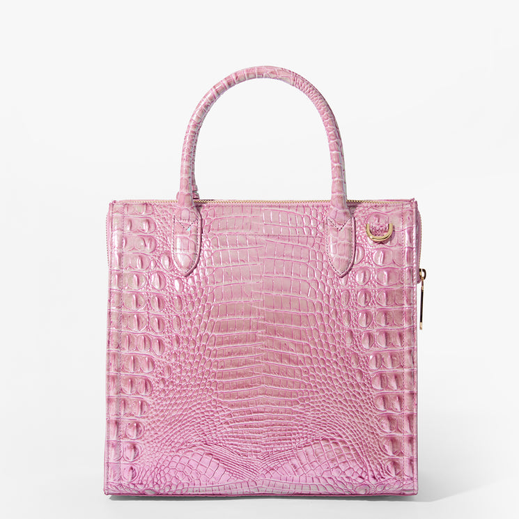 Brahmin pink structured handbag with embossed texture, two top handles, gold-tone zipper, and a small round gold emblem near the top corner, presented on a plain white background.
