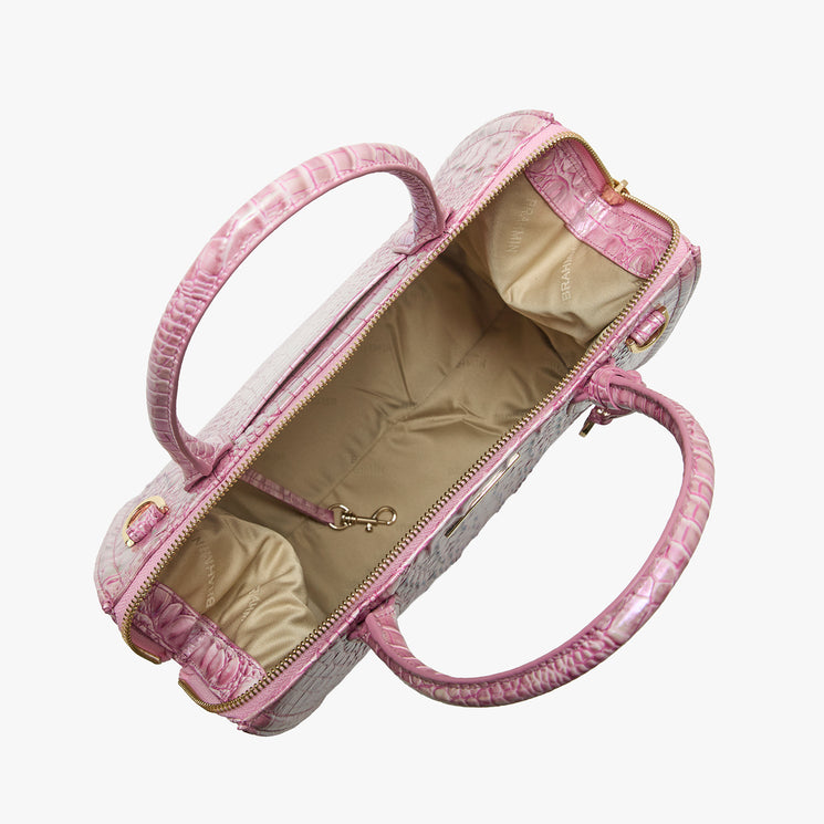 Brahmin pink handbag with embossed crocodile pattern, two top handles, gold-tone zipper hardware, beige fabric-lined interior, and inside clasp. Bag shown from above on white background.