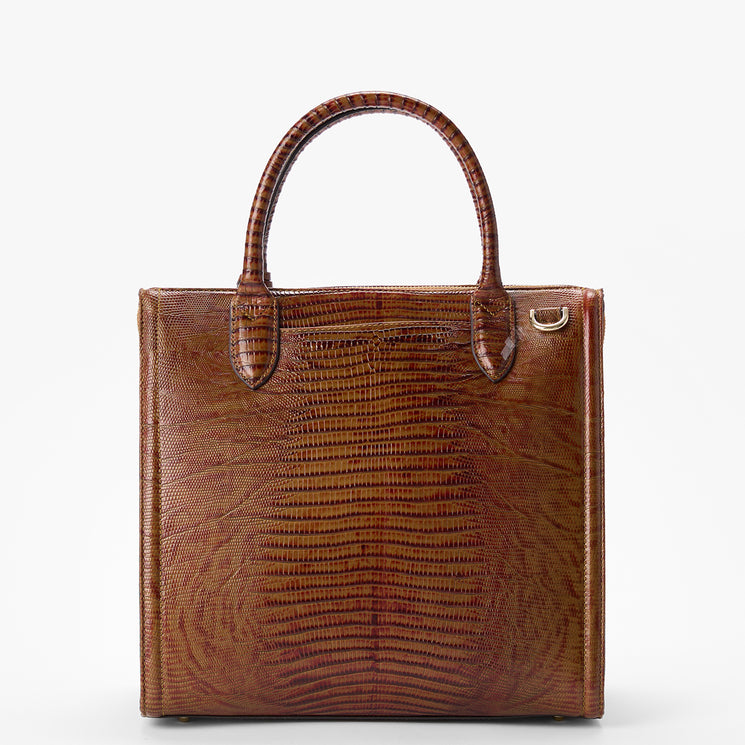 Brahmin brown square handbag featuring embossed textured pattern, two short top handles, signature hardware ring at upper right, shown against a white background. No strap or interior details visible.