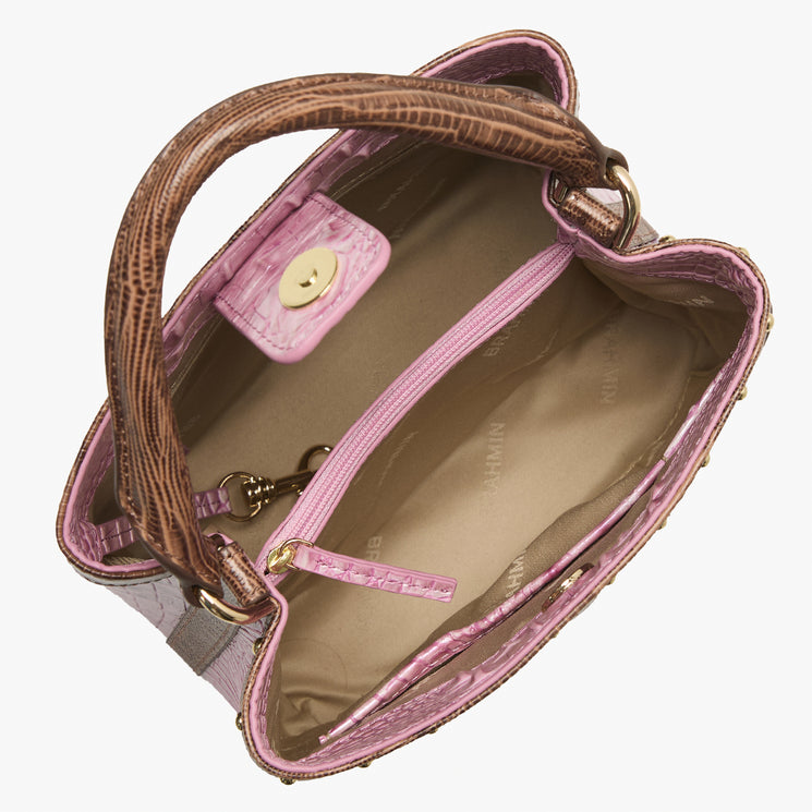 Brahmin pink and brown handbag top view with gold clasp, beige interior, zip pocket, and attached key clip. Structured silhouette showcases dual-tone design and organized compartments.