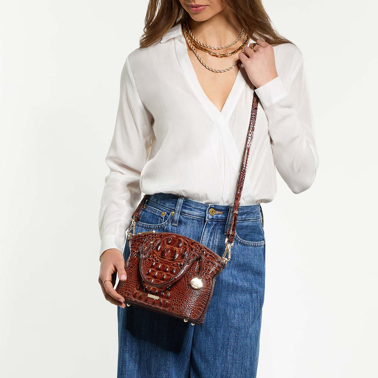 Woman wearing Duxie crossbody against a white background