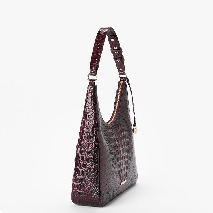 A dark burgundy crocodile-embossed shoulder bag with gold-tone hardware, shown from a three-quarter side view against a plain white background.
