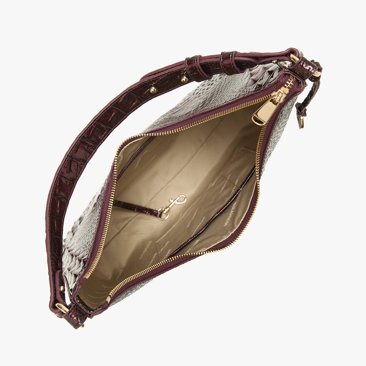 An open shoulder bag with a croc-patterned exterior in burgundy, a leather strap, and gold-tone hardware, shown on a light gray background.