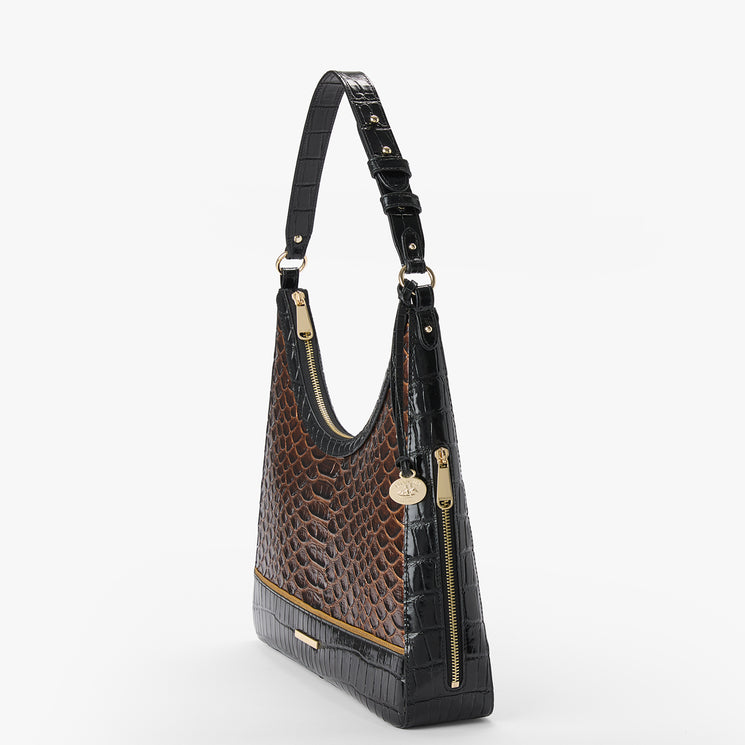 A hobo shoulder bag featuring a brown and black crocodile-embossed pattern, gold-tone hardware, and a small round brand tag on a clean white background.