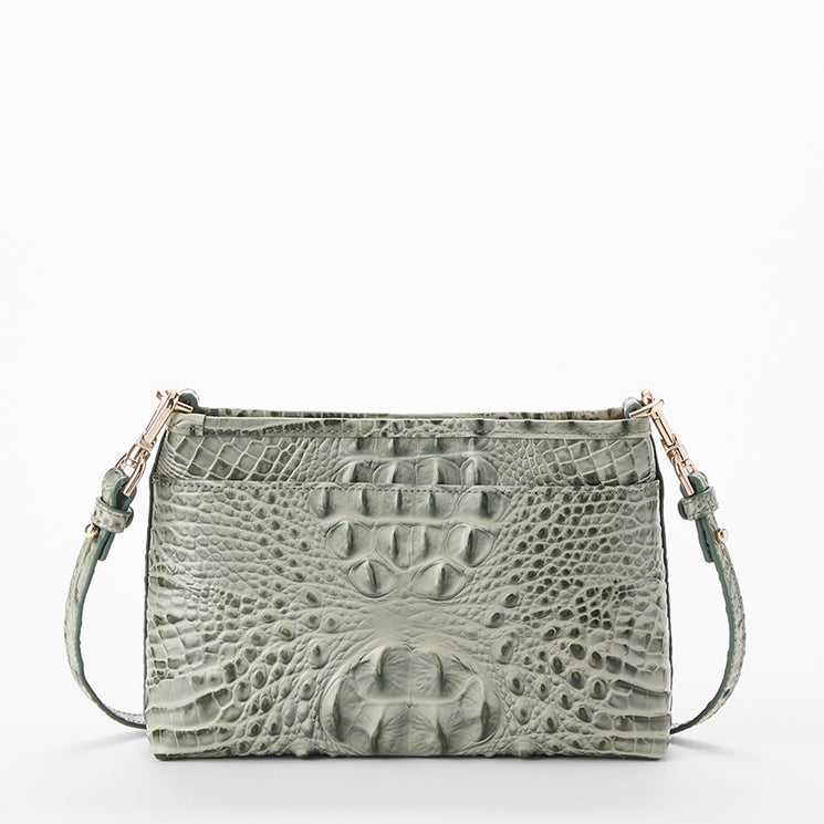 A sage green crocodile-embossed leather handbag with a matching shoulder strap and gold-tone hardware, shown against a plain white background.
