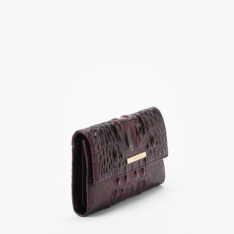 A dark burgundy faux-crocodile leather wallet with a gold-tone metal accent on the front, shown on a clean white background.