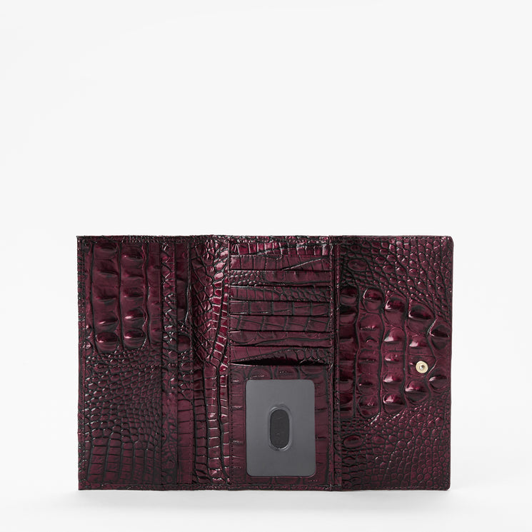 A dark burgundy crocodile-embossed leather wallet shown open against a plain white background.