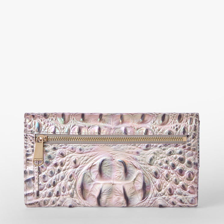Brahmin pastel pink clutch wallet with an iridescent, embossed texture and front zipper pocket, featuring a shiny finish and rectangular silhouette. Shown against a plain white background.