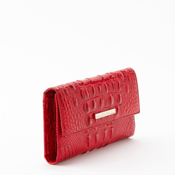 Holiday red Brahmin Cordelia wallet featuring a flap closure, gold-tone hardware, and a glossy, croc-embossed texture.