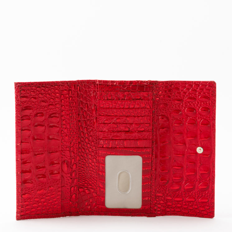Brahmin Cordelia tri-fold wallet in glossy holiday red with a textured, croc-embossed pattern, featuring multiple interior card slots and a clear ID window.