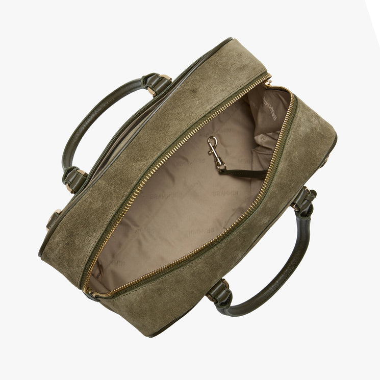 An olive green suede briefcase-style bag shown open from an overhead angle, revealing a beige interior lining and dark green handles, set against a plain white background.