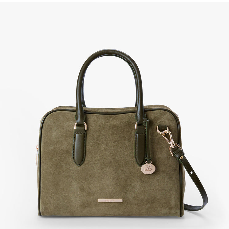 An olive green suede laptop bag with dark green leather handles and a matching shoulder strap, featuring a small round metal logo charm and a silver zipper pull, shown on a plain white background.