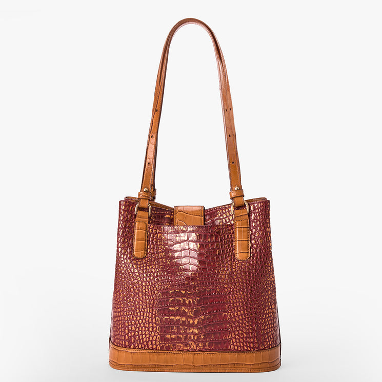 A structured shoulder tote bag with a glossy crocodile-embossed texture in reddish-brown, featuring tan leather shoulder straps and trim, set against a plain light gray background.