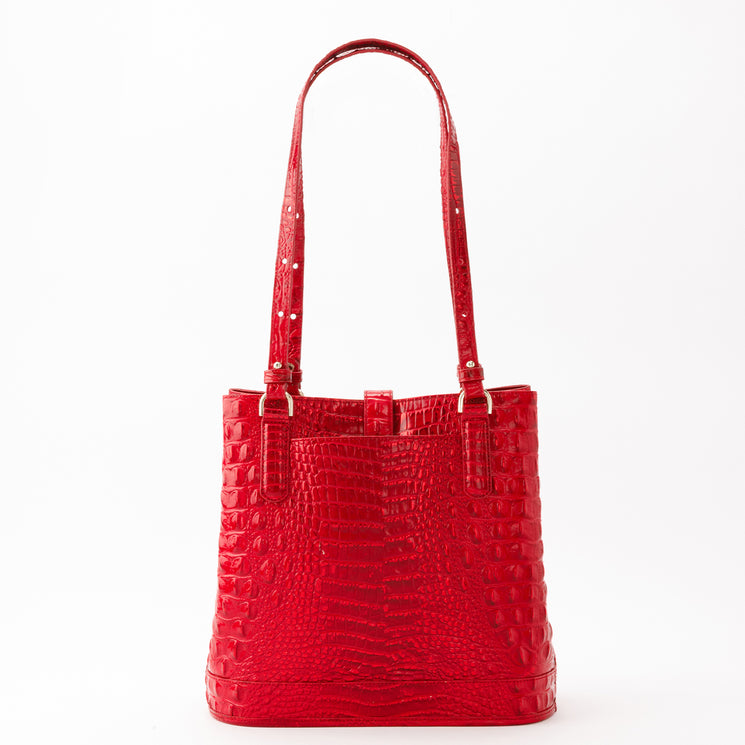 Brahmin Fiora bucket bag in bright red with a vertical rectangular silhouette, long thin shoulder straps, and a glossy embossed texture.