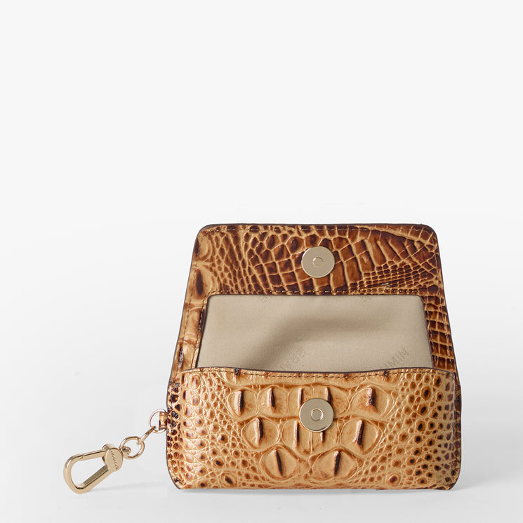 Brahmin small brown coin purse with embossed texture, gold snap buttons, and a gold keychain clasp. Features beige interior. Purse is displayed open on a white background, showing compact silhouette and rich detailing.