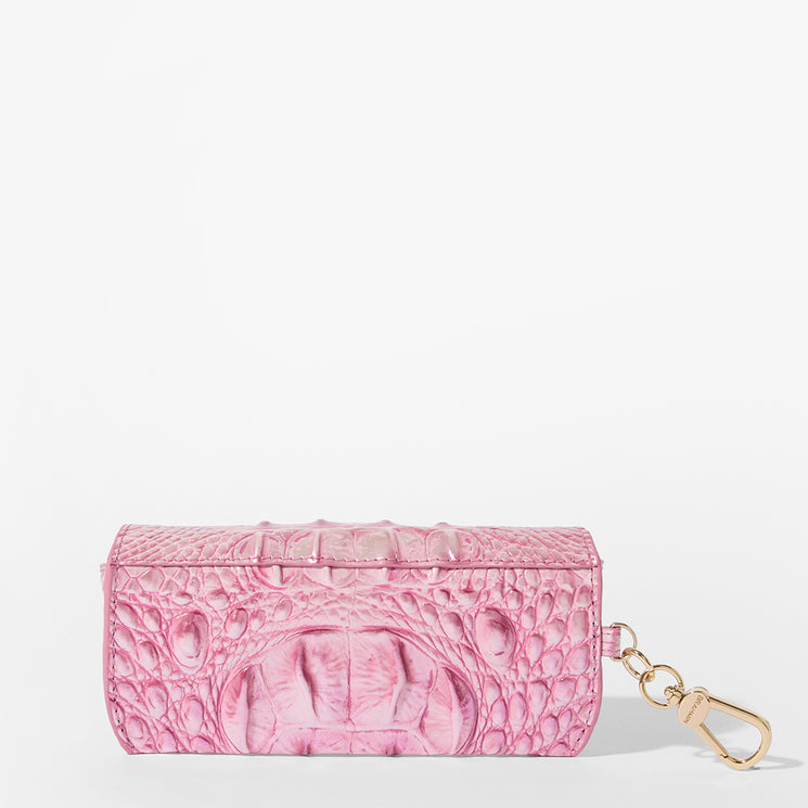 Brahmin pink embossed case with a gold-tone keychain clip, shown against a white background. The case features a textured pattern and structured silhouette, perfect as an accessory or bag charm.