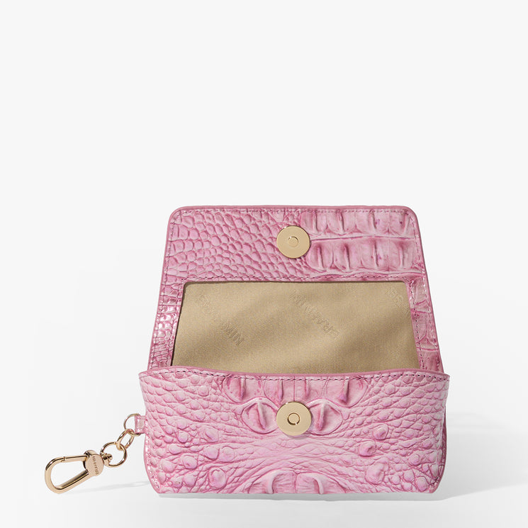 Brahmin small pink textured wallet with gold snap button closure, beige interior, and gold keychain clip, shown open on a white background. Features compact silhouette and elegant hardware details.