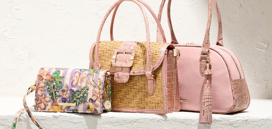 Three handbags with different designs and colors on a light background