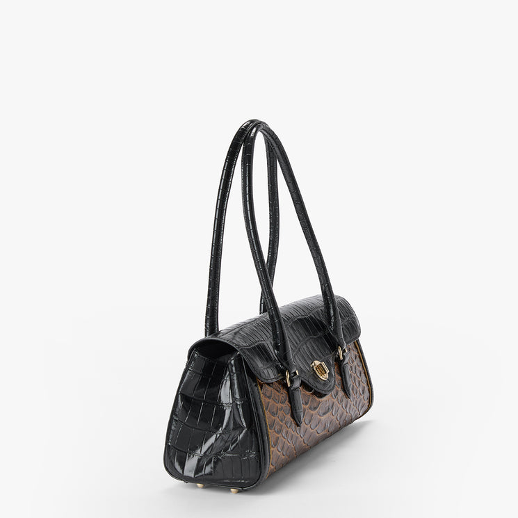 A structured handbag with a black crocodile-embossed front and handles, and a brown snakeskin-patterned body, shown on a light gray background.