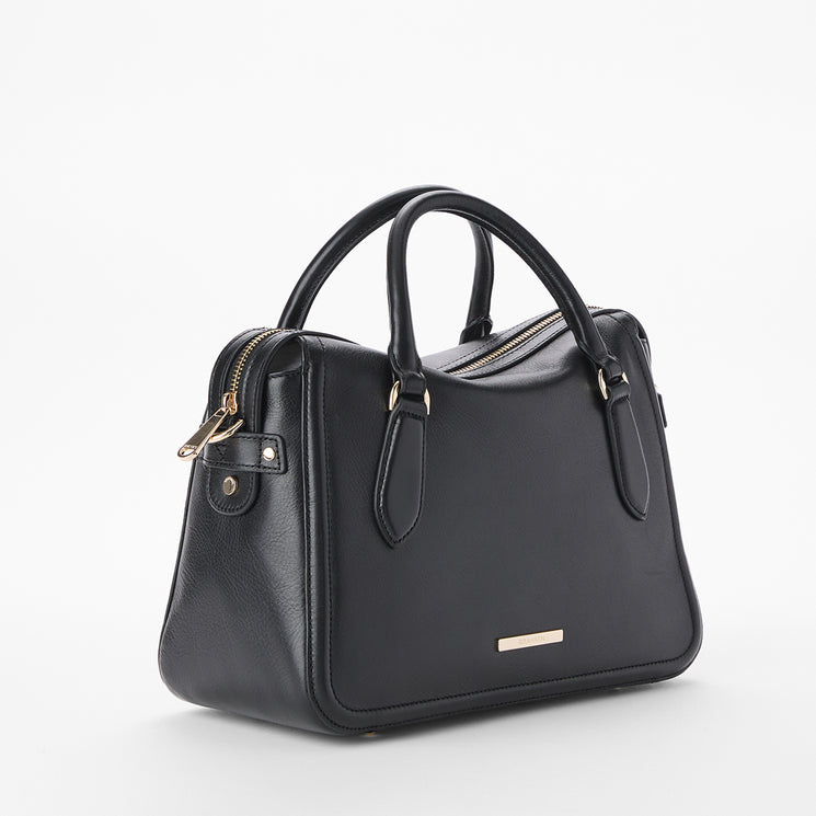 Brahmin black handbag with gold-tone hardware, two rolled handles, a structured silhouette, zippered top closure, and smooth texture. Shown in front view on white background.